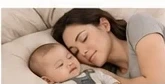 Caregiver and baby resting together